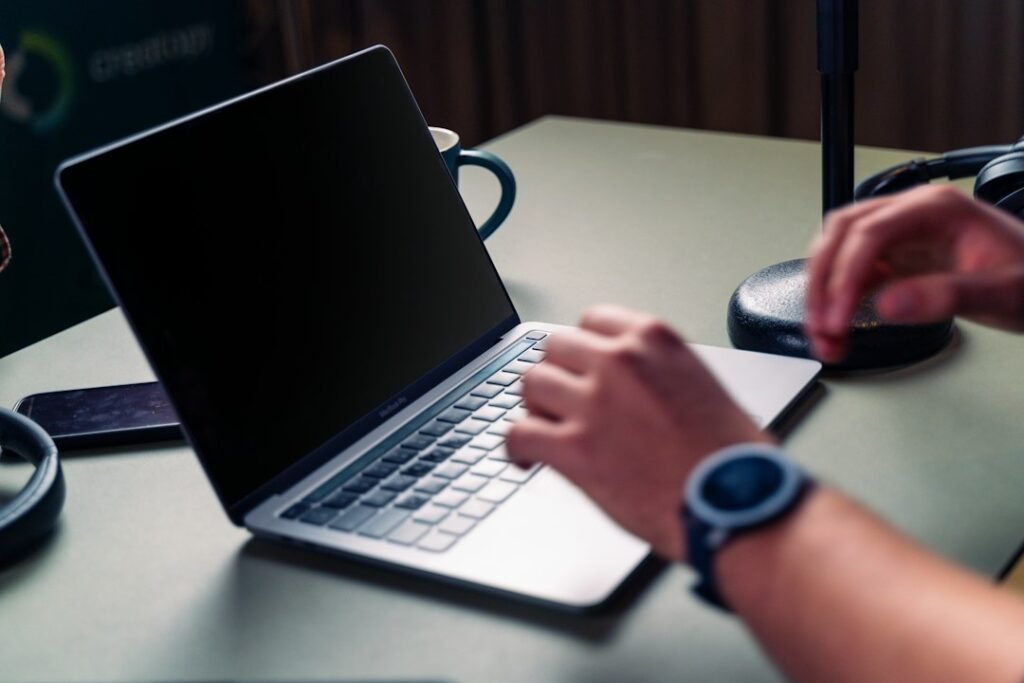 Small business owner researching answer engine optimization on a laptop to get cited by AI search tools