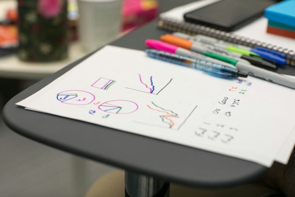 Designer sketching logo ideas on paper while planning the branding cost for a small business
