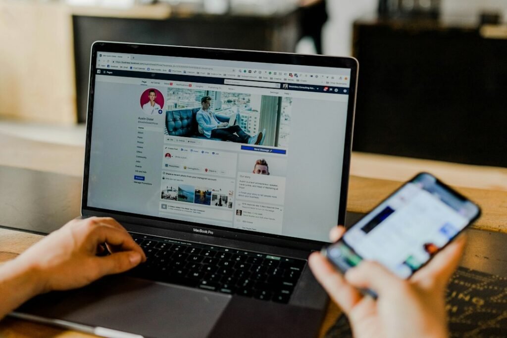 Business Facebook page open on a laptop and phone, illustrating how much Facebook ads cost for small businesses