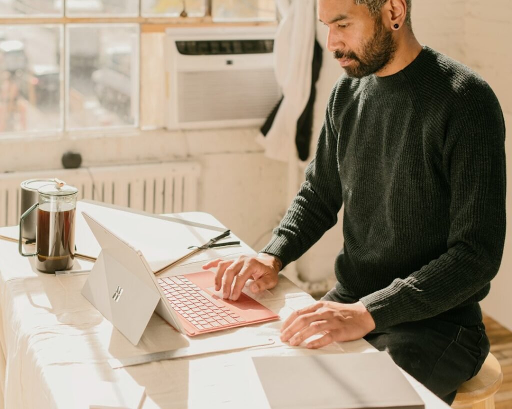 Small business owner at a laptop working out how much does SEO cost for a monthly marketing budget