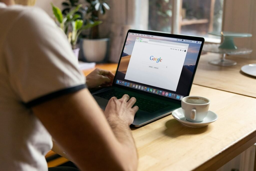 Person running a Google search on a laptop, checking how to rank in Google AI Overviews